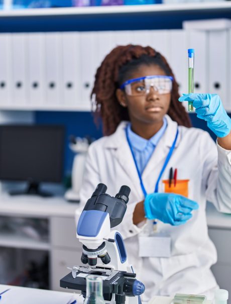 African american woman scientist holding test tube at laboratory